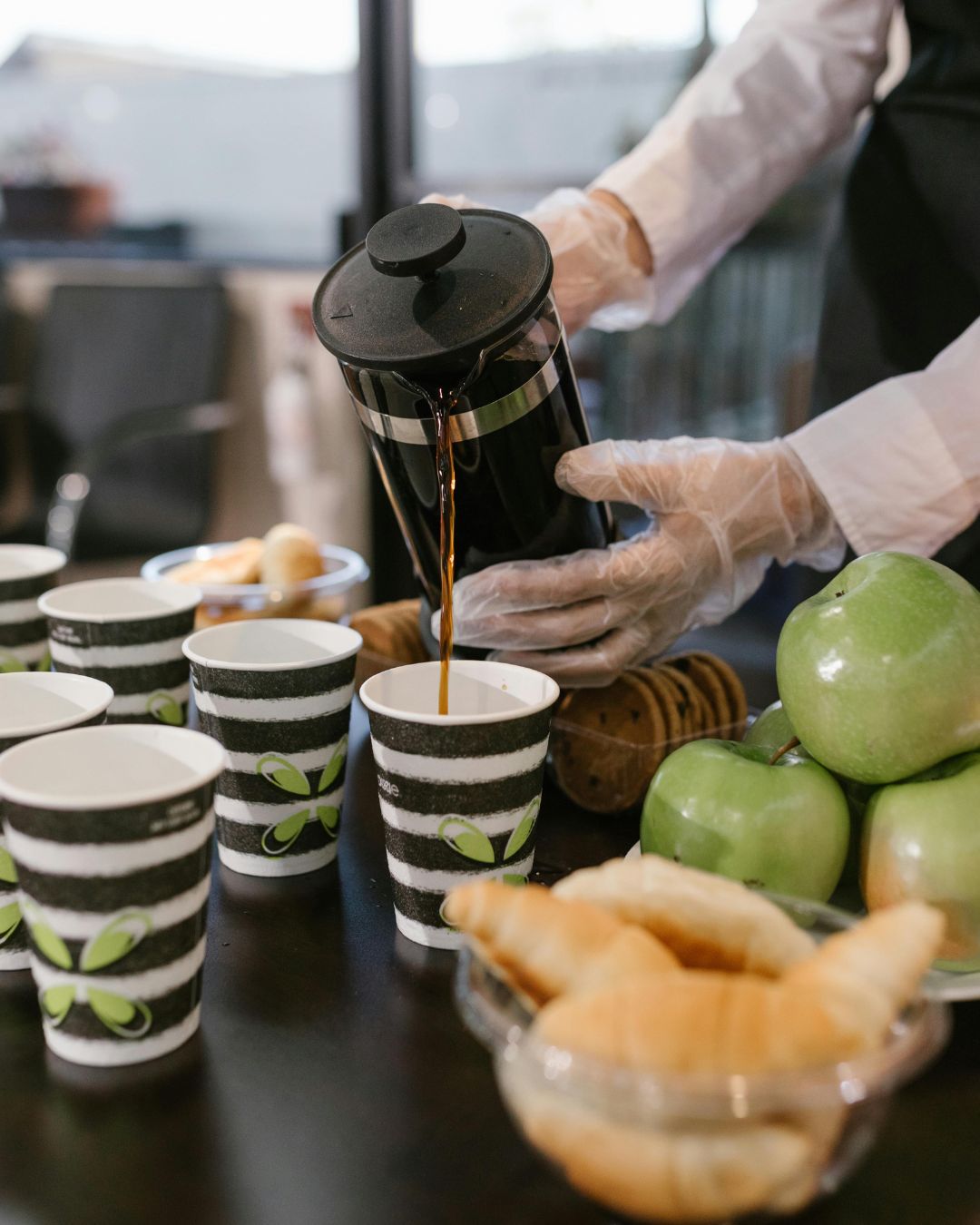 Preparing and serving dishes at a live food catering counter during an event